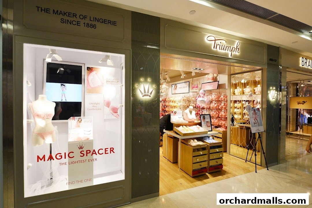 The Triumph lingerie shop features a window display with a mannequin and a sign for Magic Spacer.