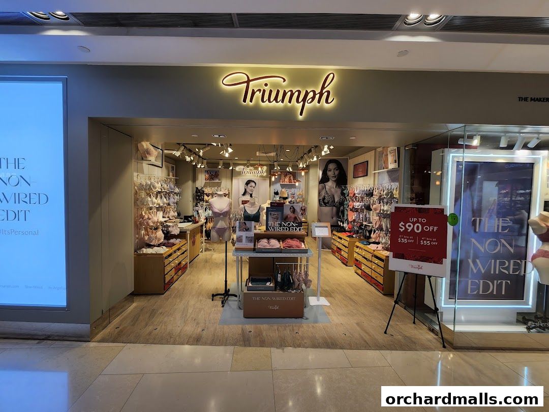 The Triumph lingerie shop front displays bras and offers a discount promotion.