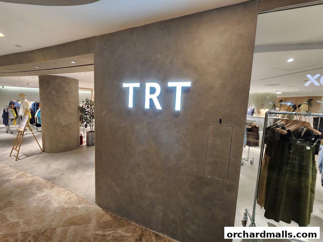 The entrance to TRT - The Restyle Trait clothing store with illuminated signage.