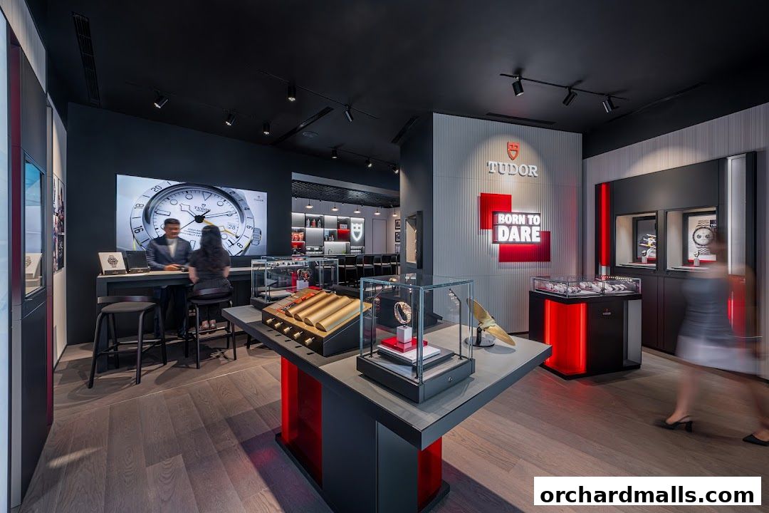 Interior of a Tudor watch boutique with display cases and a large screen showing a watch.
