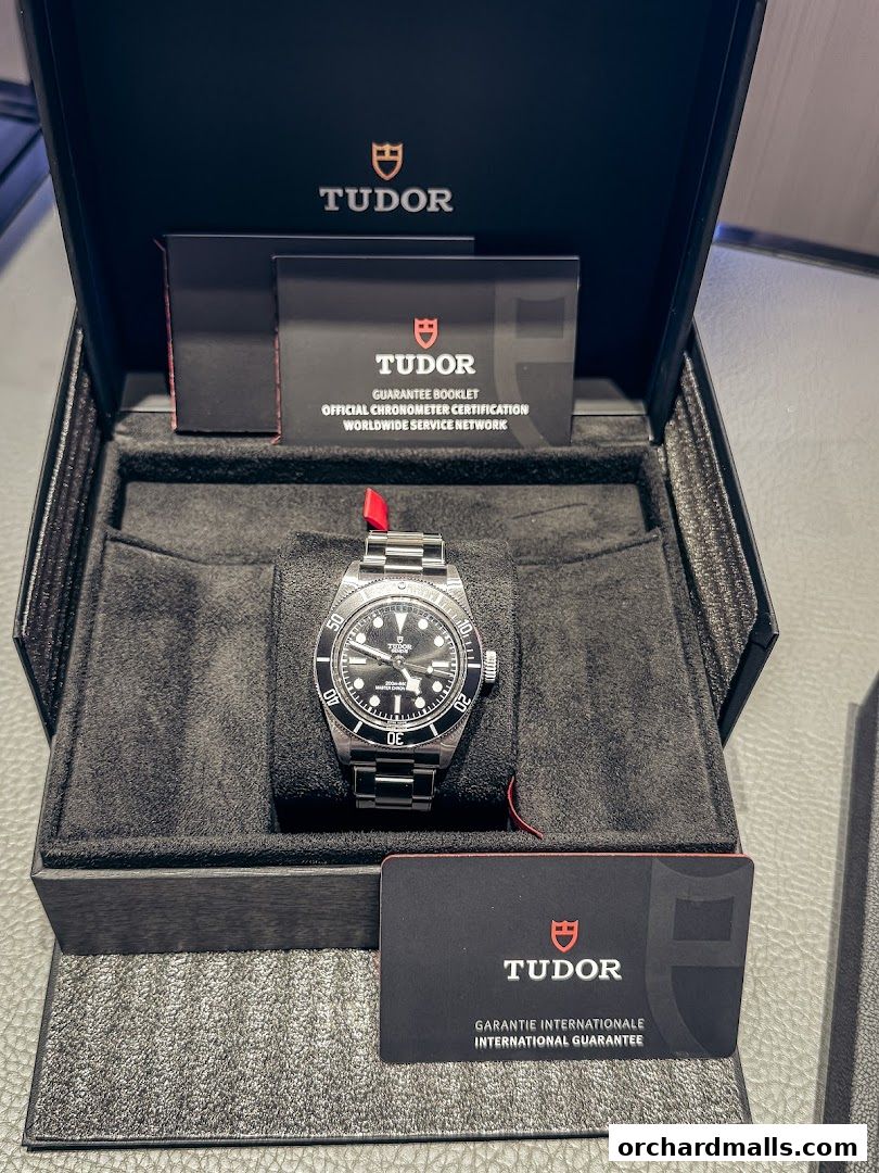 A Tudor watch in its presentation box with guarantee and certification booklets.