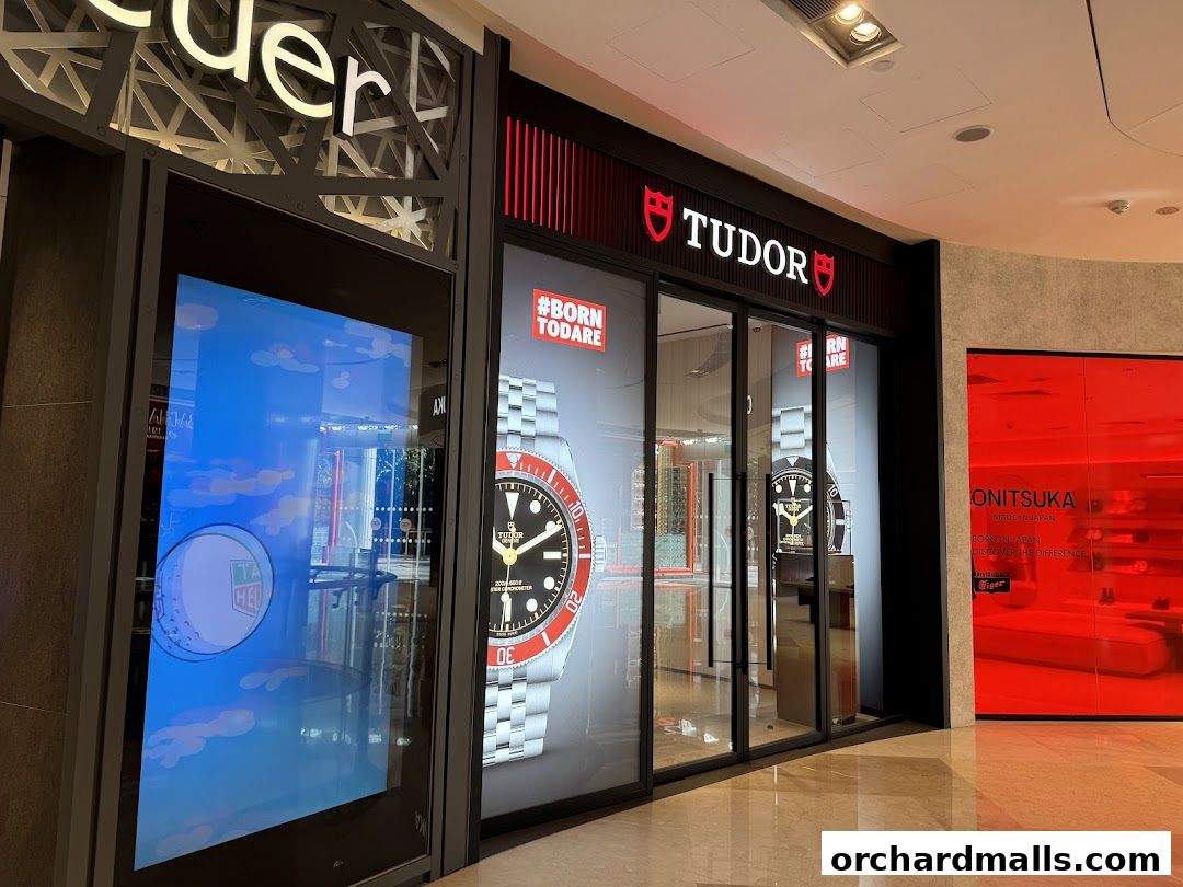 The Tudor Boutique shop front with a large watch display and digital screen.