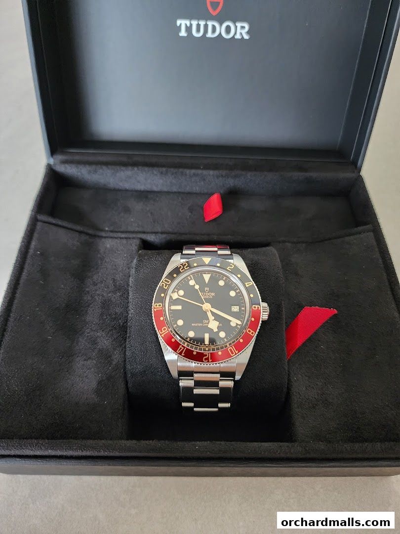 A Tudor GMT watch displayed in its presentation box.