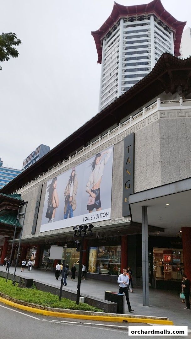 Exterior of the Tudor department store featuring a large Louis Vuitton advertisement.