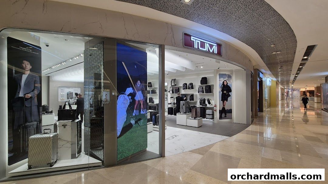 The TUMI ION Orchard store features a modern facade with displays of luggage and accessories.