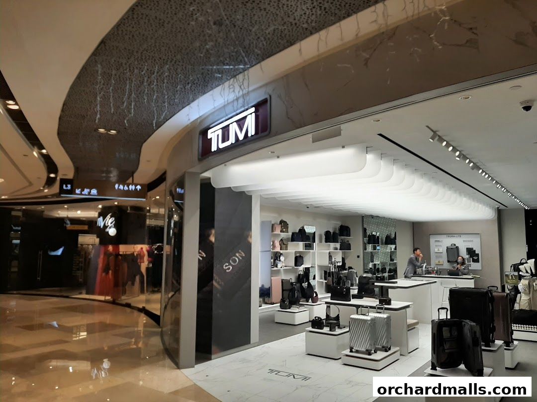 Interior view of a TUMI store showcasing luggage and bags on display.
