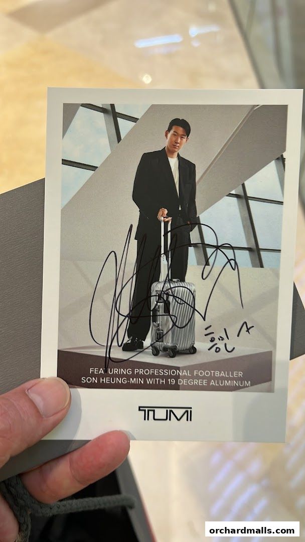 A card featuring Son Heung-Min with a TUMI suitcase and his autograph.