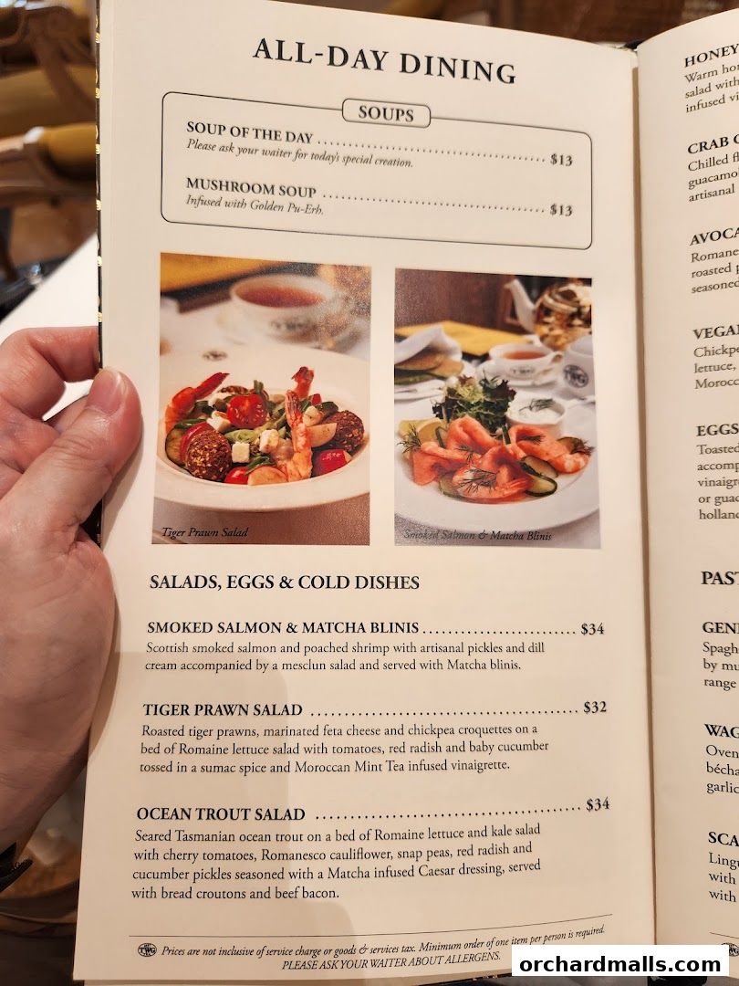 A menu from TWG Tea featuring soups and salads with accompanying images.