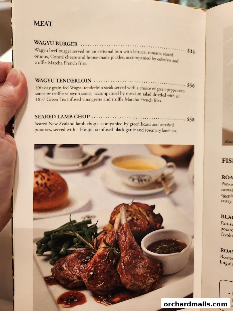 A menu page from TWG Tea featuring meat dishes and a photo of lamb chops.