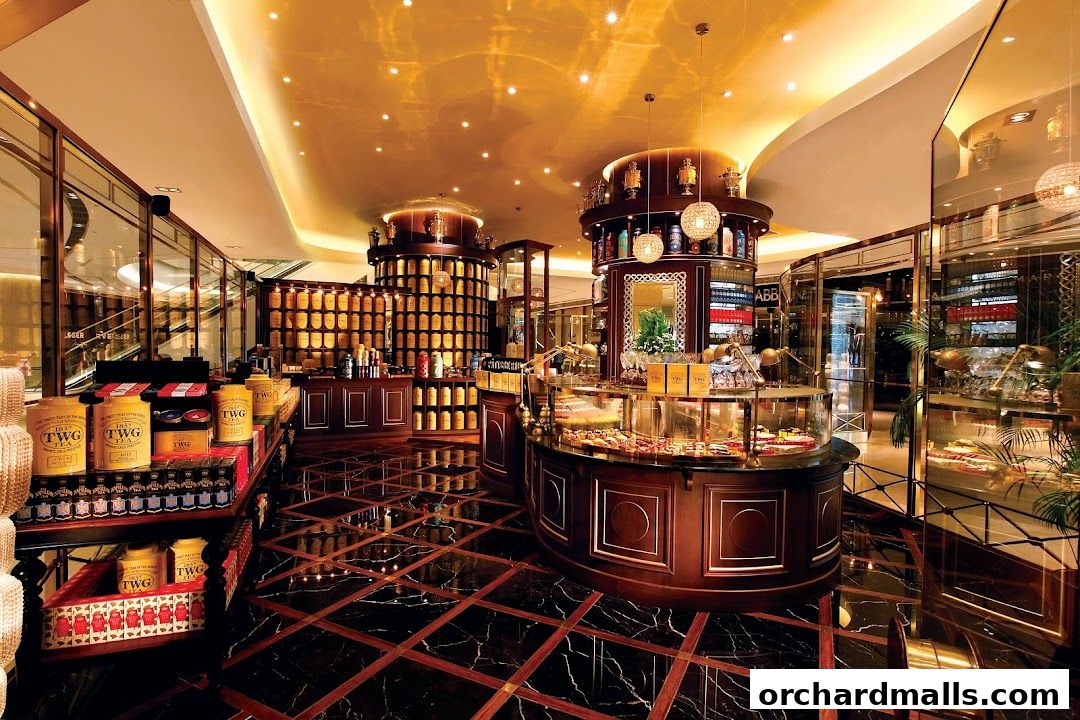 Interior of a luxurious TWG Tea shop with displays of tea tins and pastries.