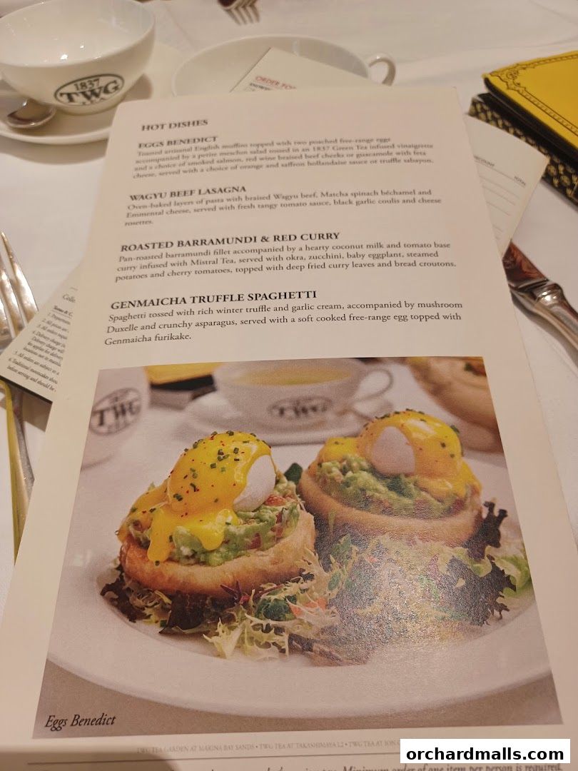 A menu from TWG Tea featuring 'Eggs Benedict' and other hot dishes.