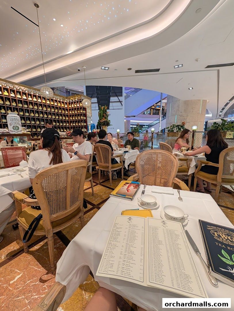 Interior of TWG Tea at ION Orchard with diners enjoying tea and a view of the mall.