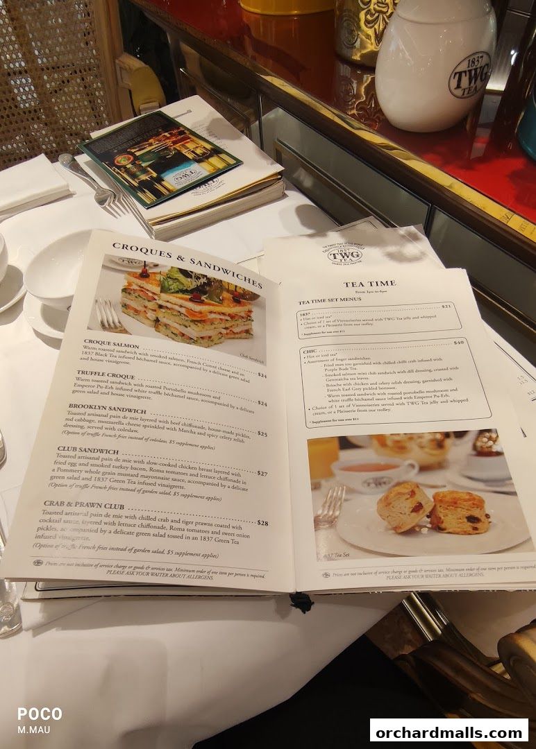 A menu from TWG Tea featuring sandwiches and tea set options with prices.