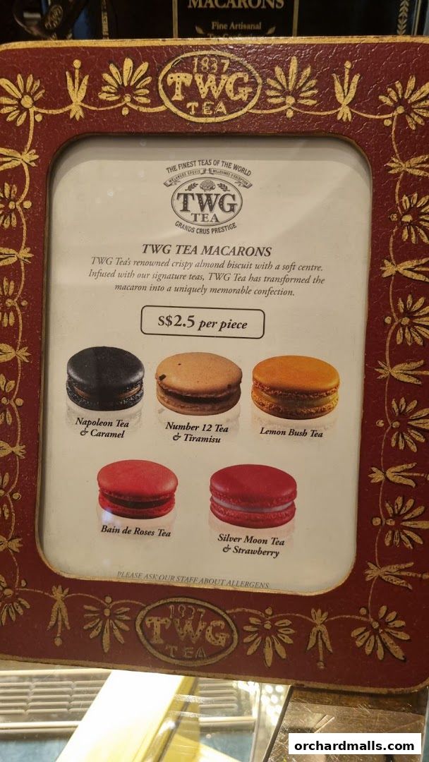 A display of TWG Tea macarons with their names and prices.
