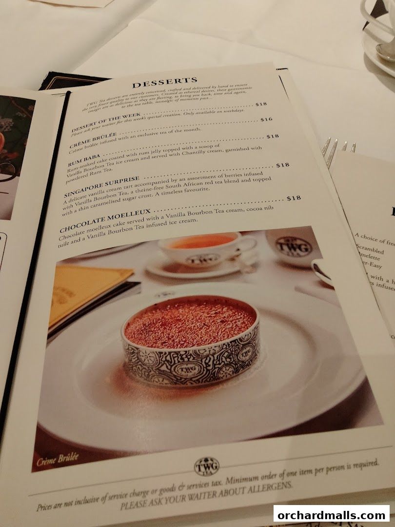 A menu from TWG Tea featuring desserts like Crème Brûlée and Rum Baba.