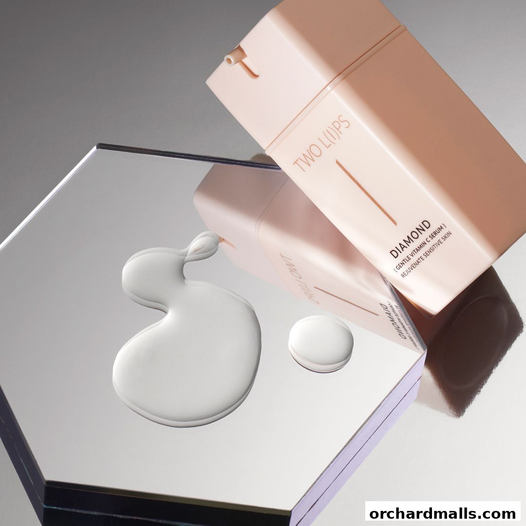 A bottle of TWO LIPS Diamond Gentle Vitamin C Serum with a drop of serum on a reflective surface.
