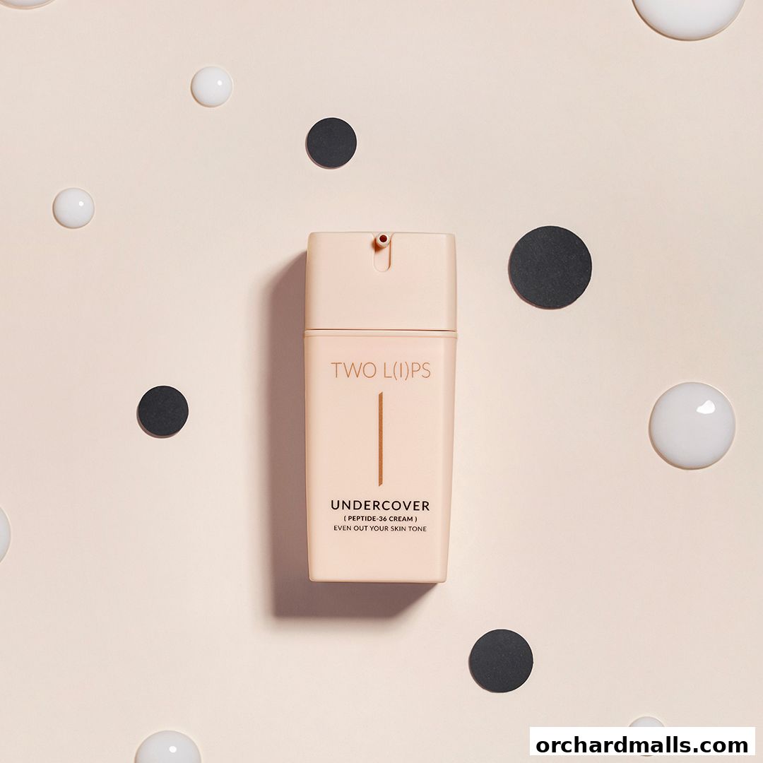 A bottle of TWO L(I)PS Undercover Peptide-36 Cream surrounded by decorative spheres.