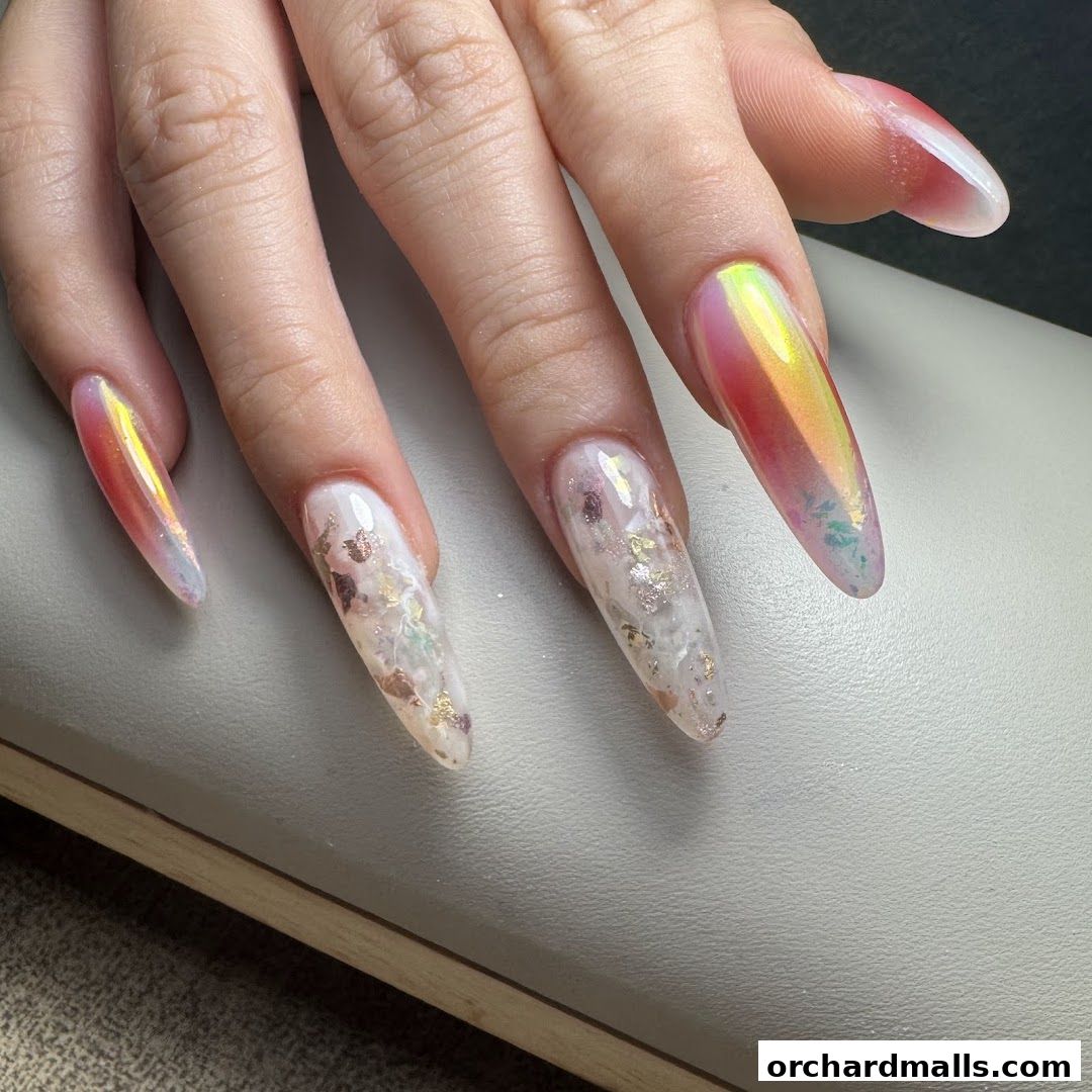 Close-up of a hand with long, almond-shaped nails featuring iridescent and inlaid designs.