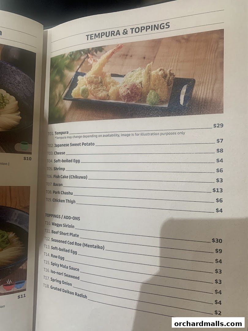 A menu page from Udon Shin Singapore featuring tempura and toppings with prices.