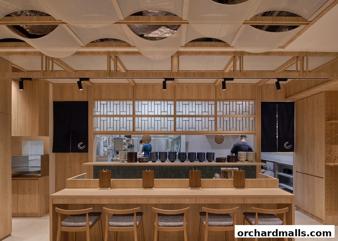 Interior of Udon Shin Singapore with wooden counter seating and open kitchen.