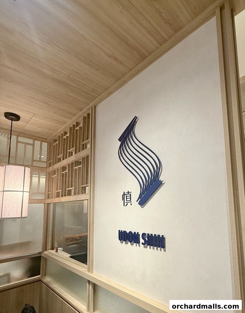Interior view of Udon Shin Singapore with its logo and Japanese-inspired decor.