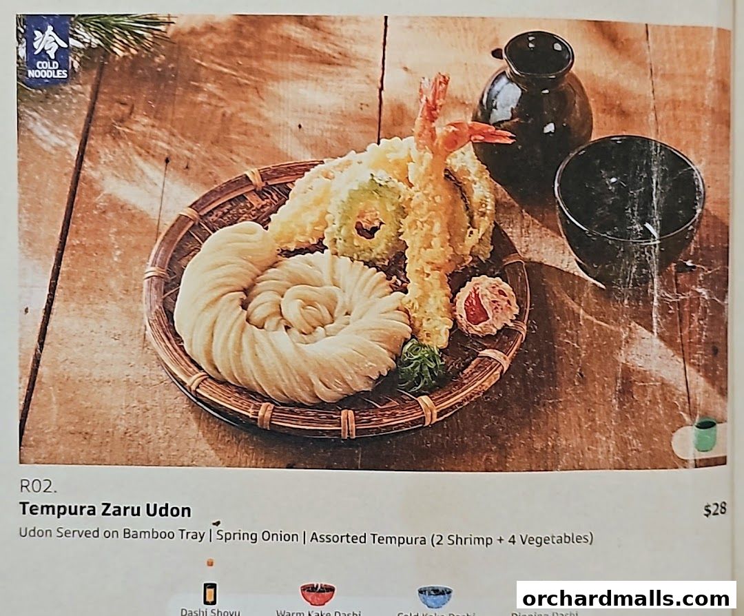 A close-up of Tempura Zaru Udon served on a bamboo tray with assorted tempura.