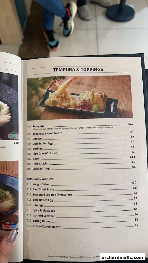 A menu page from Udon Shin Singapore featuring tempura and toppings with prices.