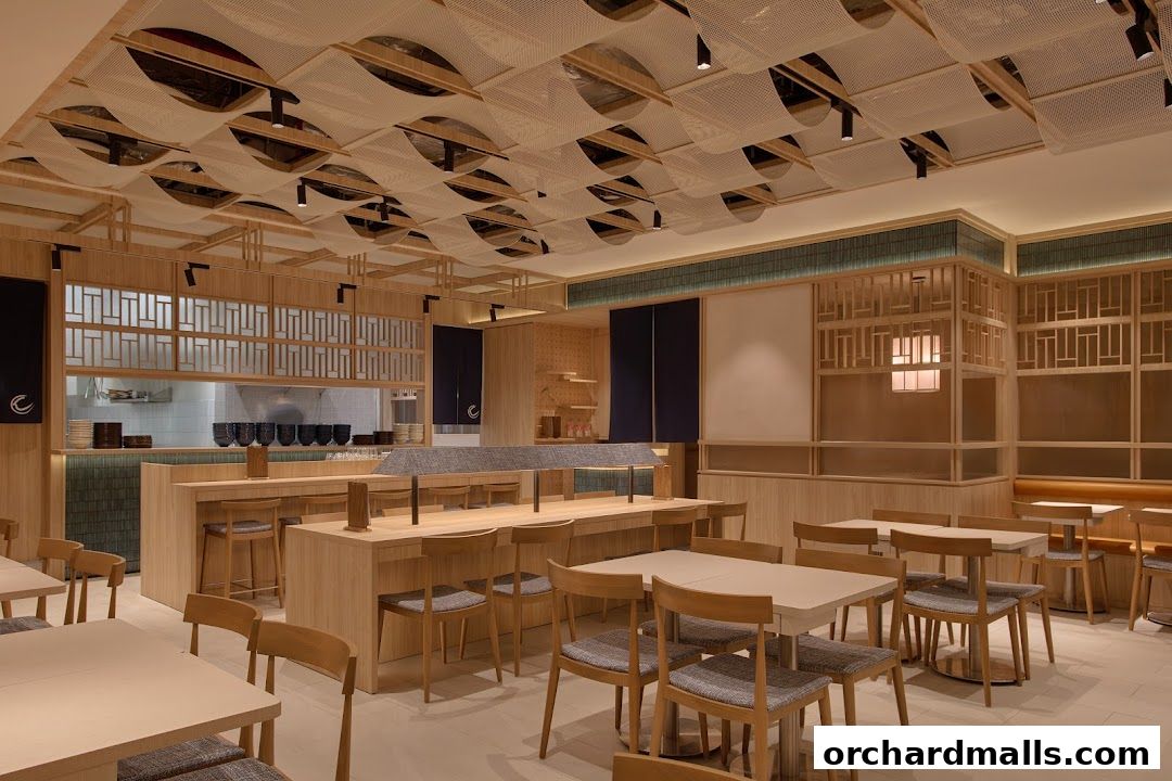 Interior of a modern Japanese restaurant with wooden tables, chairs, and decorative ceiling.