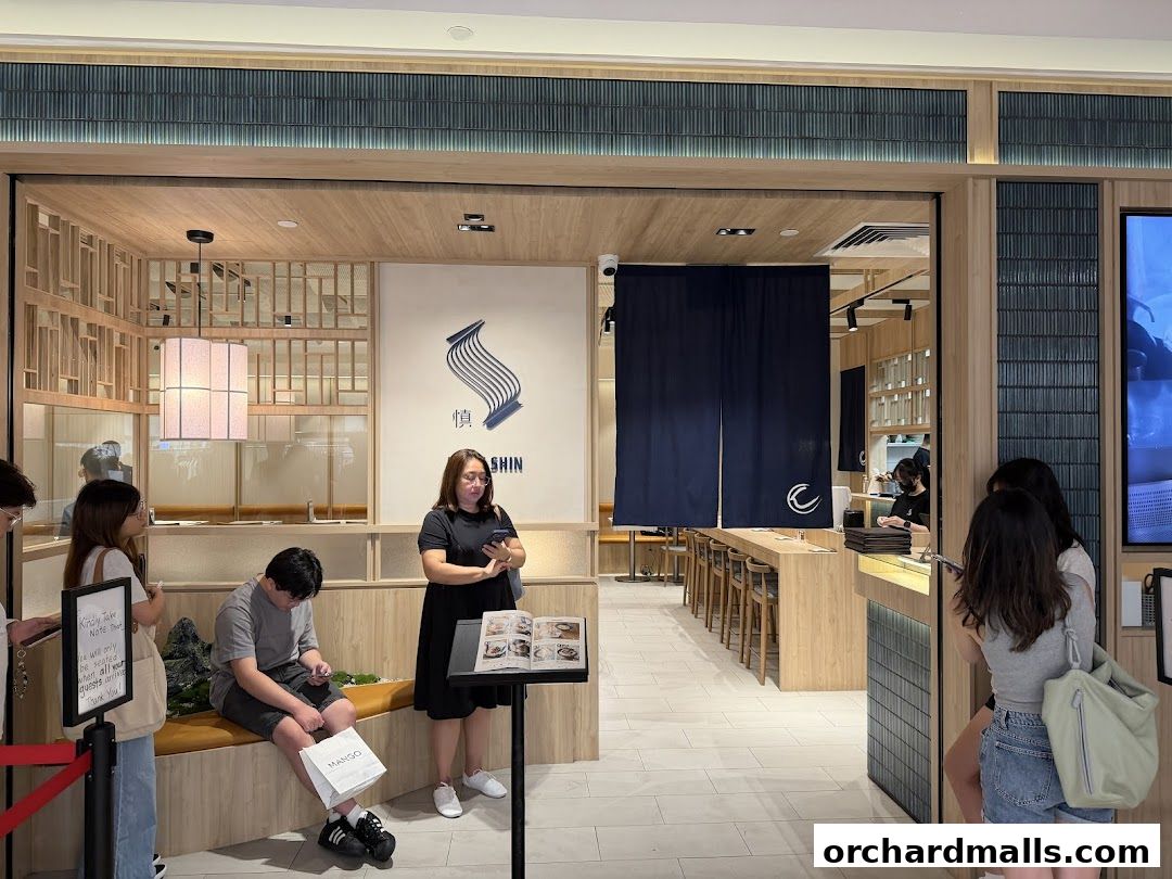 People waiting outside Udon Shin Singapore, a Japanese restaurant with a modern interior.