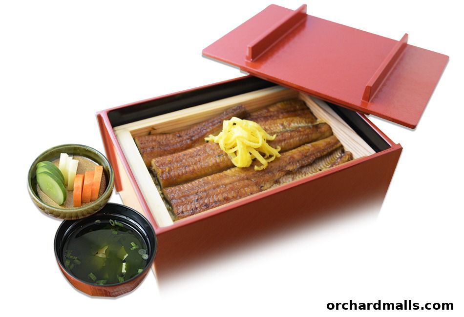 A bento box filled with grilled eel over rice, served with pickles and soup.