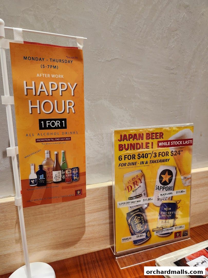 Promotional signs for happy hour and Japanese beer bundles at Unazen.