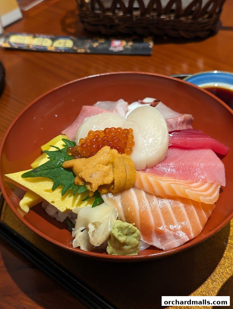 A close-up of a colorful Chirashi bowl filled with fresh seafood and rice.