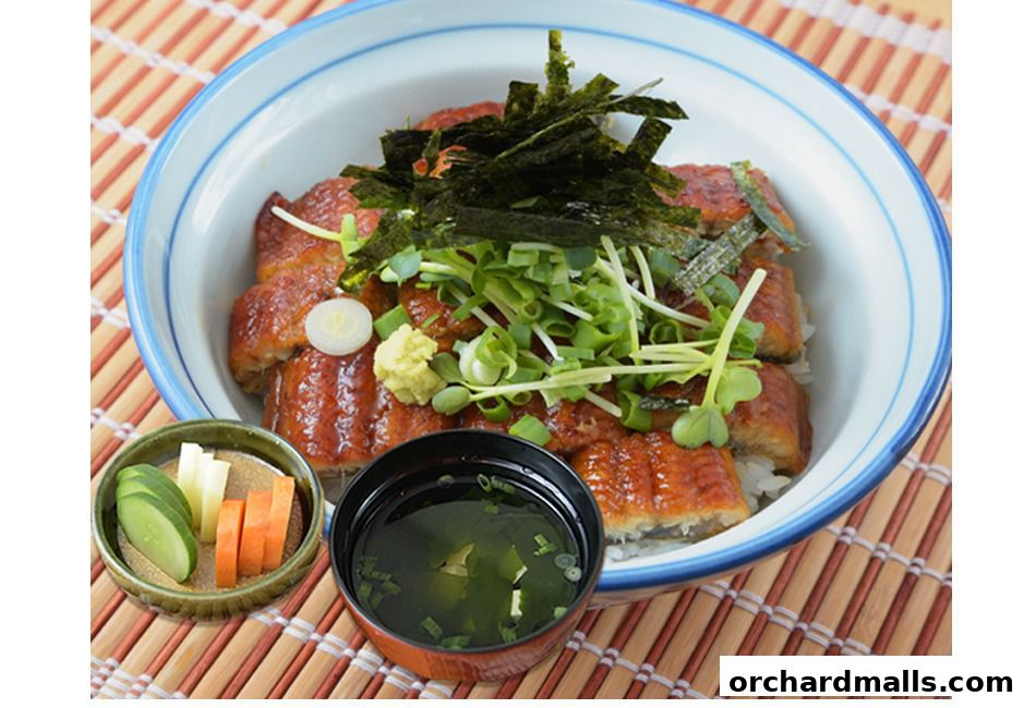 A bowl of Unazen eel over rice, served with pickles and soup.