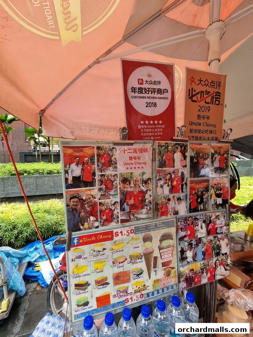 A street vendor stall displaying photos and a menu for traditional wafer ice cream.
