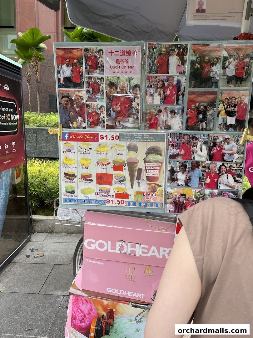 A colorful ice cream cart with photos of happy customers and a menu of traditional wafer ice cream flavors.