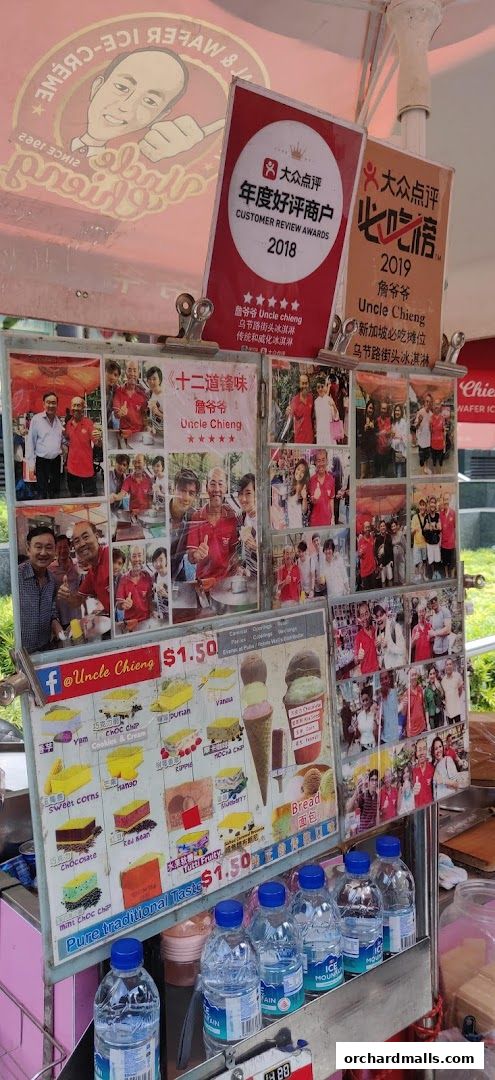 A display board for Uncle Chieng Traditional Wafer Ice Cream with photos and menu items.