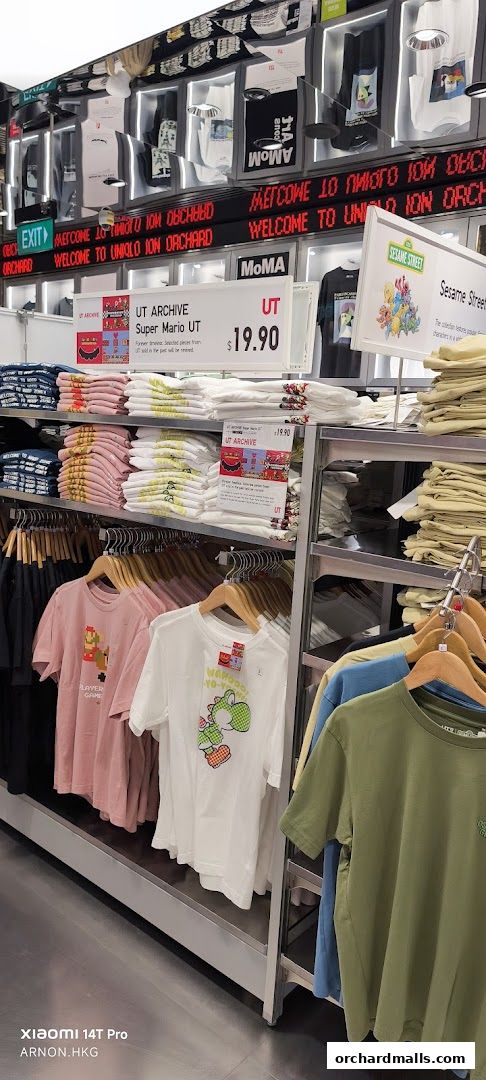 A display of graphic t-shirts, including Super Mario and Sesame Street designs, at UNIQLO.