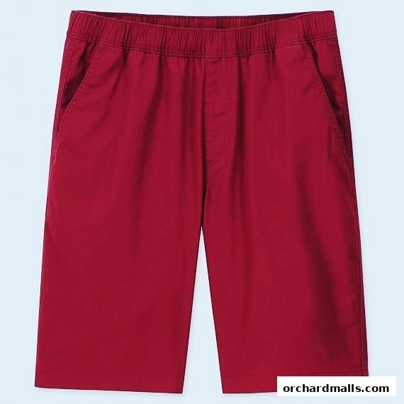 A close-up view of red shorts with an elastic waistband and pockets.