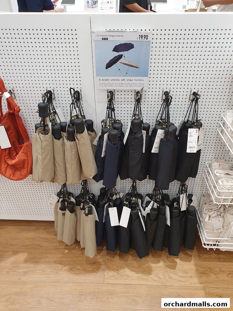 Display of compact UV protection umbrellas in various colors at UNIQLO.