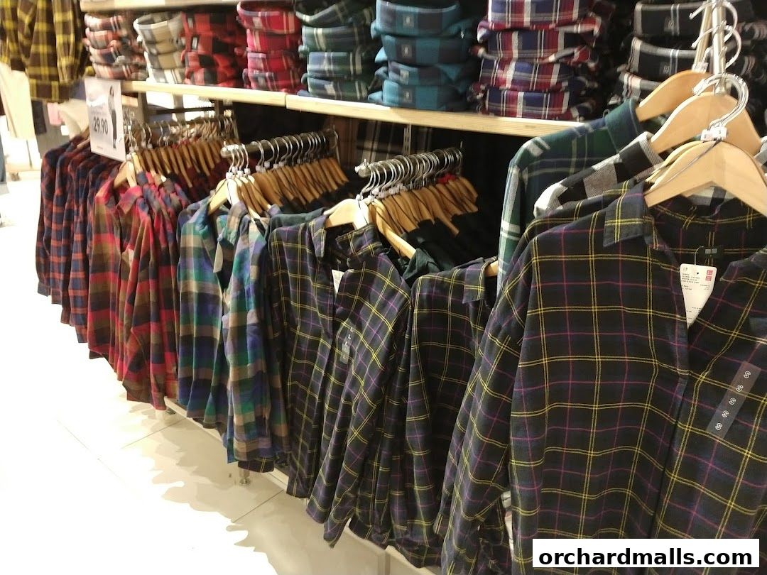 A display of various plaid shirts hanging on racks in a retail store.