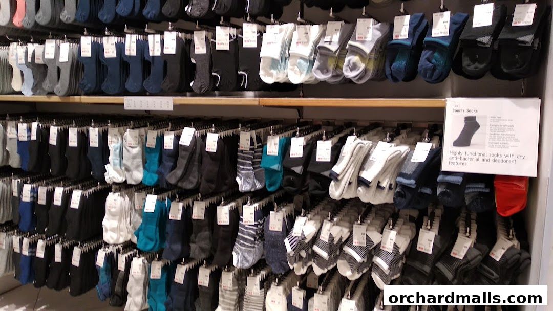 A display of various socks in different colors and styles on shelves.