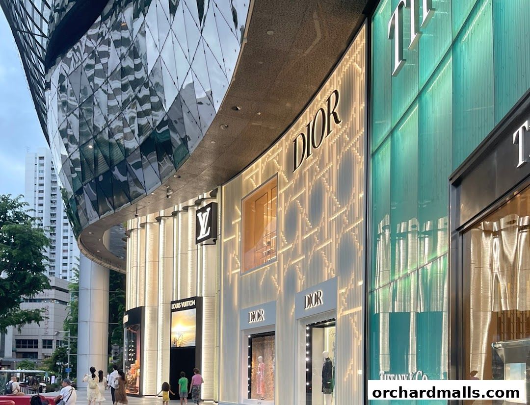 Luxury fashion brands Louis Vuitton, Dior, and Tiffany & Co. storefronts on a modern street.