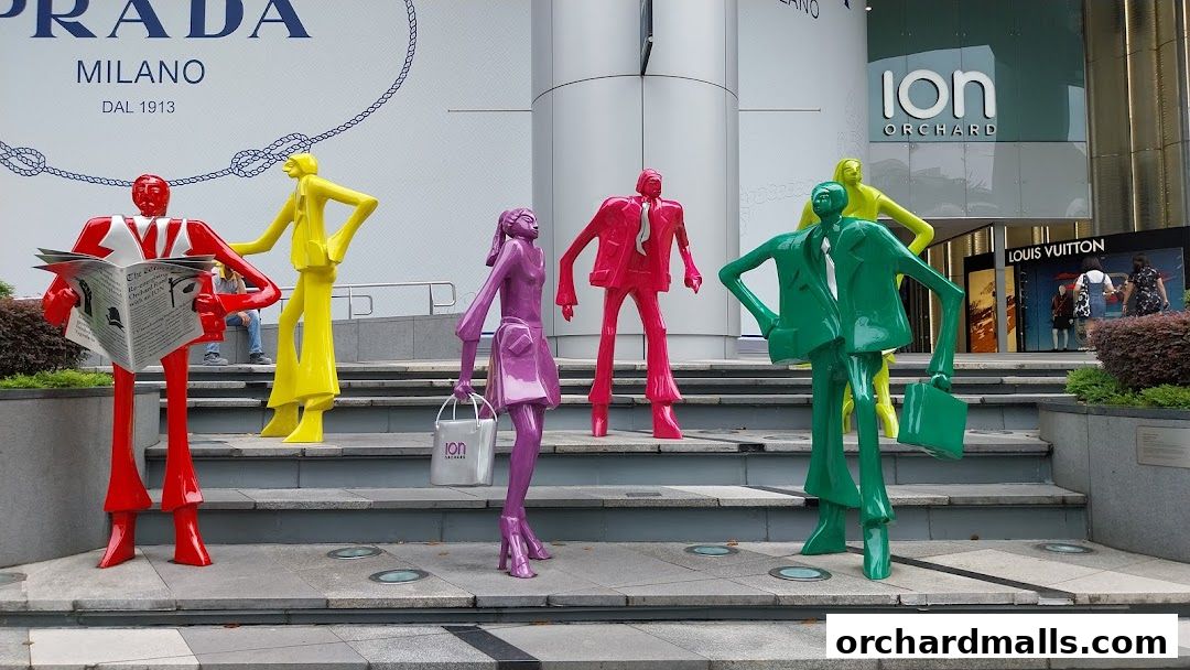 Colorful sculptures of people in front of ION Orchard mall and Louis Vuitton store.