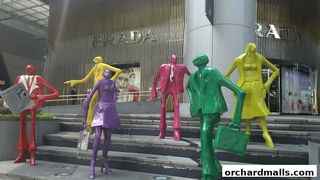 Colorful statues stand in front of the Prada store.