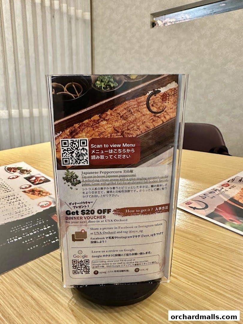 A menu stand with a QR code and information about a $20 dinner voucher.