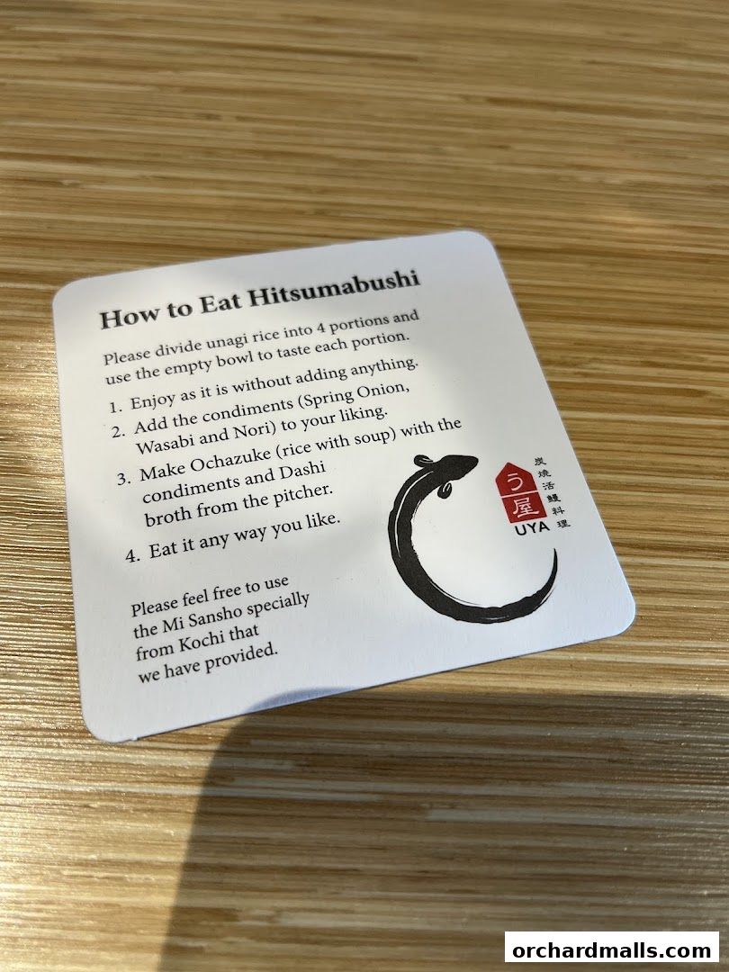 A card explaining how to eat Hitsumabushi with UYA Unagi Singapore branding.