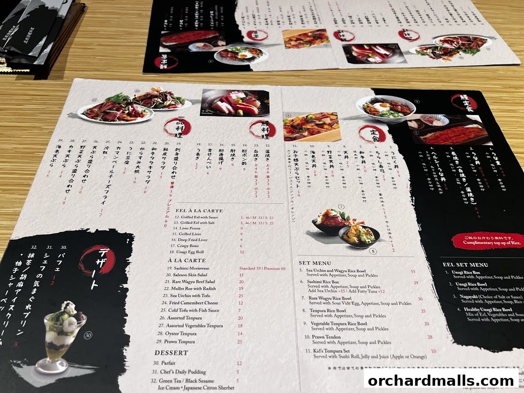 A close-up view of a Japanese restaurant's menu, featuring eel dishes, set menus, and desserts.