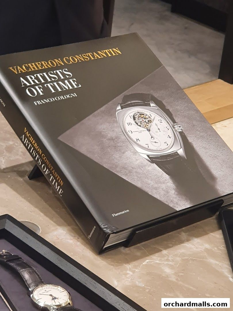 A book titled 'Vacheron Constantin Artists of Time' is displayed on a table.
