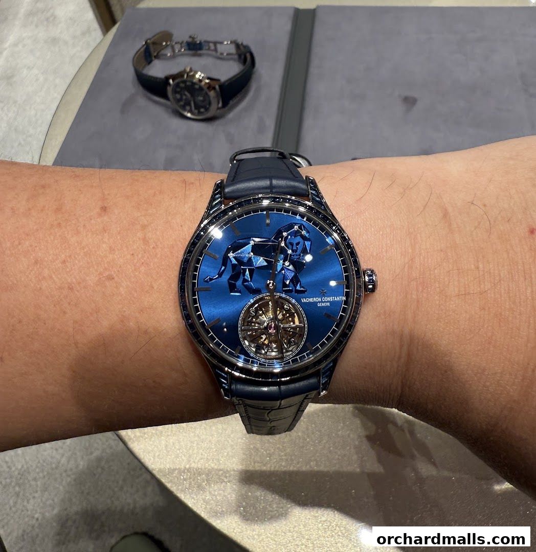 A close-up of a Vacheron Constantin watch with a blue dial featuring a lion design and a tourbillon.