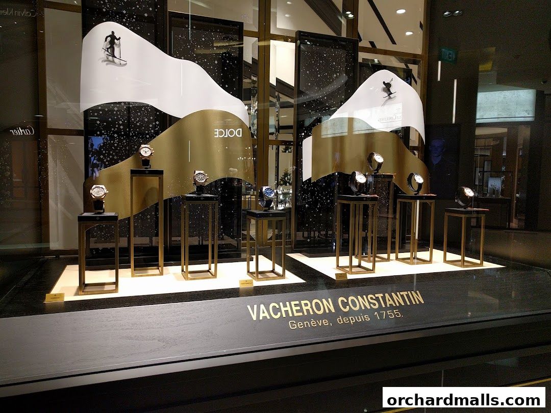 Vacheron Constantin watch store window display featuring elegant watches on golden stands.